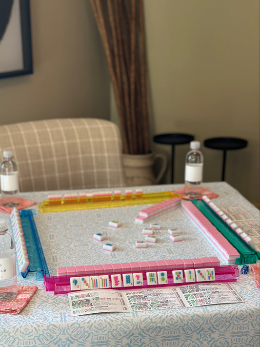 Board game set up on a table with water bottles and chairs in the background
