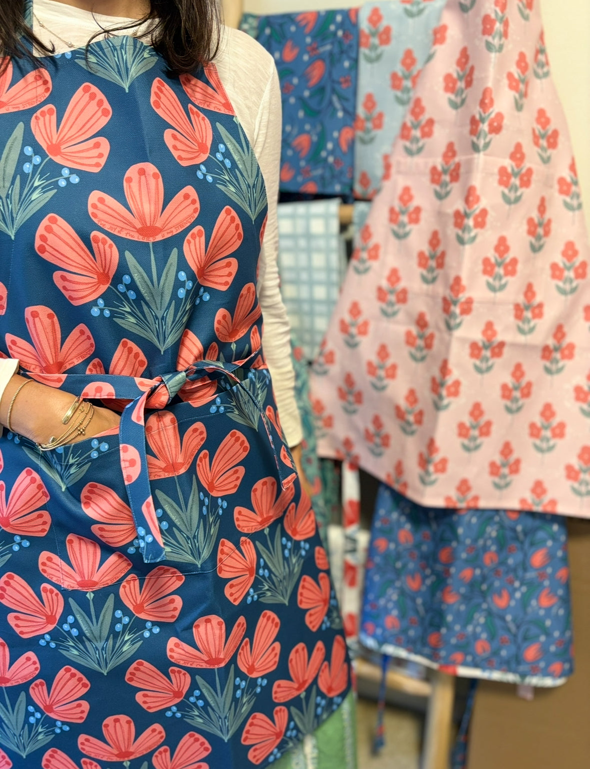 Posey & Byrd aprons combine everyday function with faith-filled design. Scripture-inspired prints make cooking and serving a joy