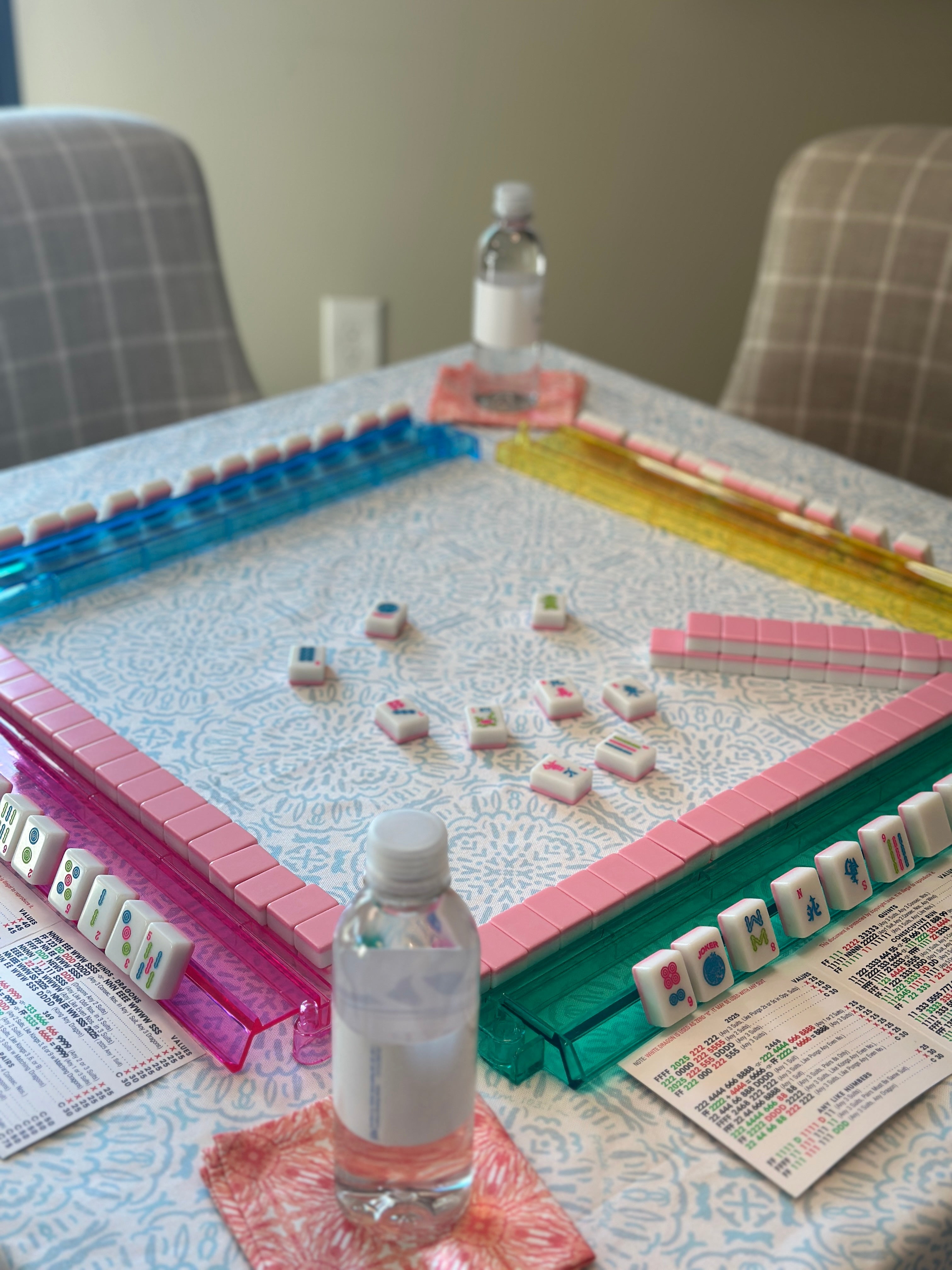Mahjong game set up on a table with scripture tablecloth